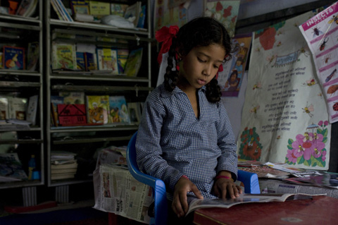 Room to Read, Girl in Uttarkhand, India reads in her classroom library (Dana Smillie)